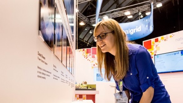 Woman looking at information on a conference stand