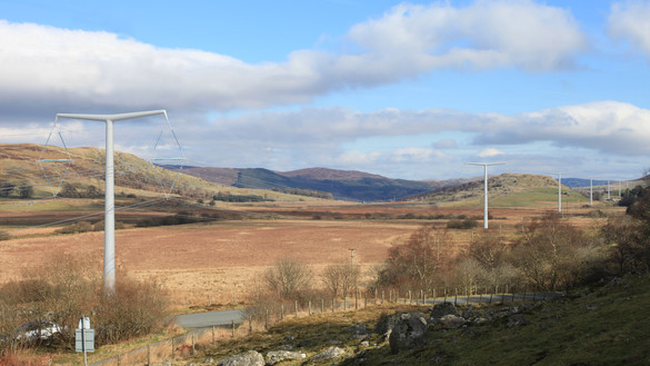 Artist impression of new T-pylons marching across a landscape