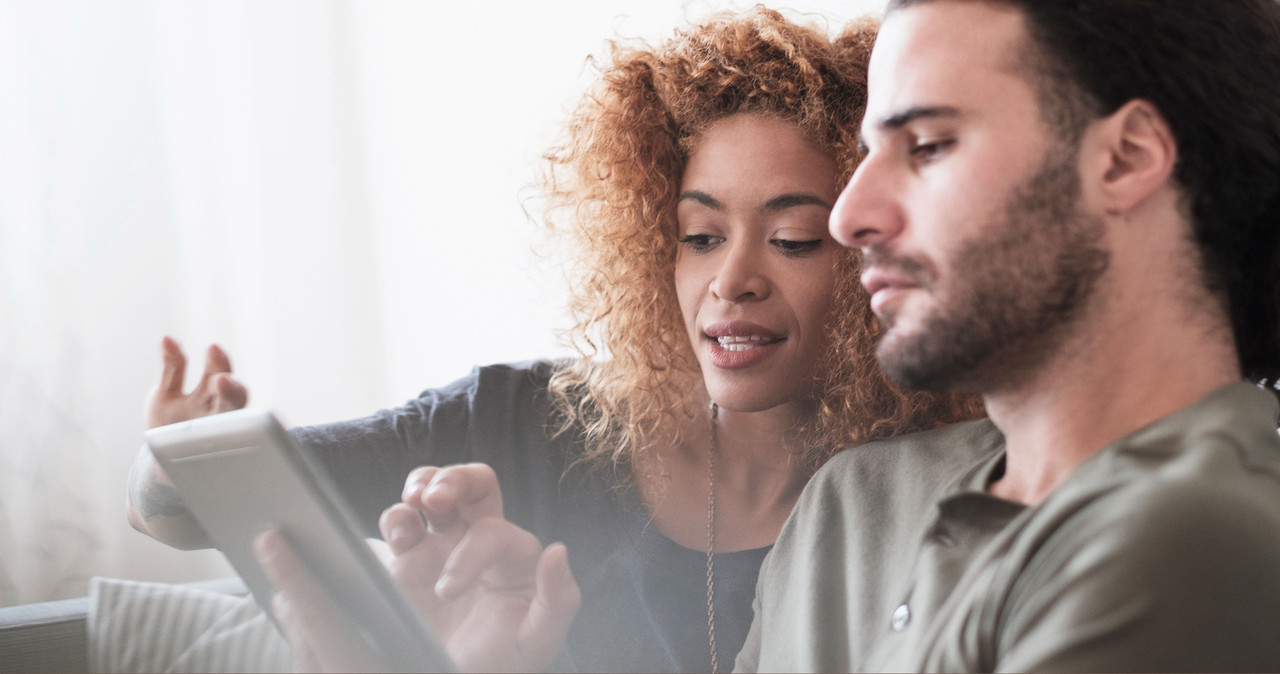 Man and woman looking at tablet