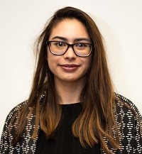 Young woman engineer with glasses smiling into camera