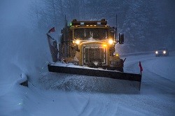 Snowplow in snowy conditions for National Grid article Holiday Heroes