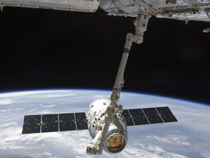 Space X Dragon satellite orbiting earth