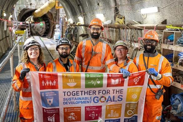 Our Sustainable Development Goals People wearing PPE in a tunnel holding up a banner with National Grid's Sustainable Development Goals