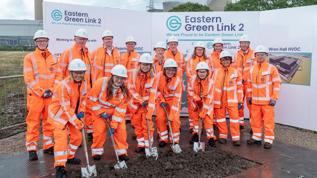EGL2_GroundbreakingCeremony_640x360.jpg Group of people wearing orange overalls and hardhats holding spades at ceremonial groundbreaking for Eastern Green Link 2