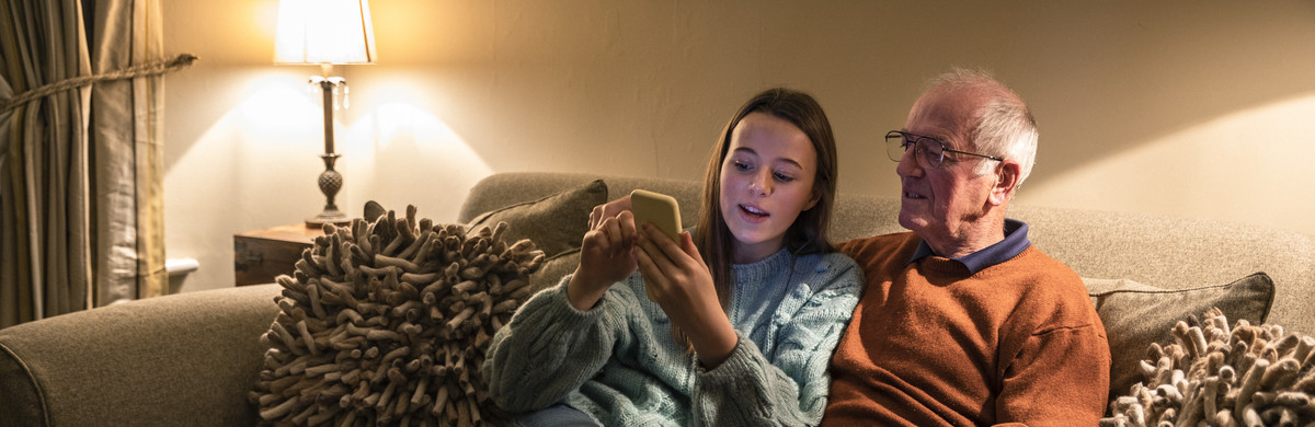 Girl and elderly man looking at a phone.jpg