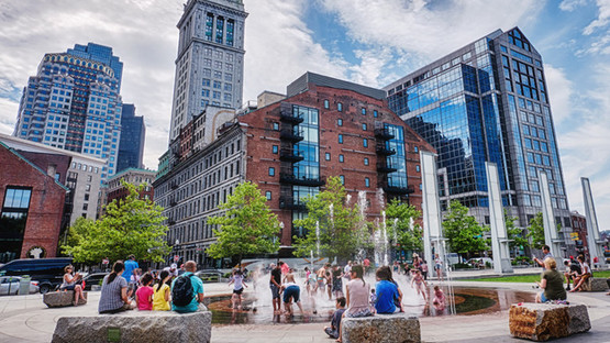 People sitting by and playing in a fountain in Boston, Massachusetts